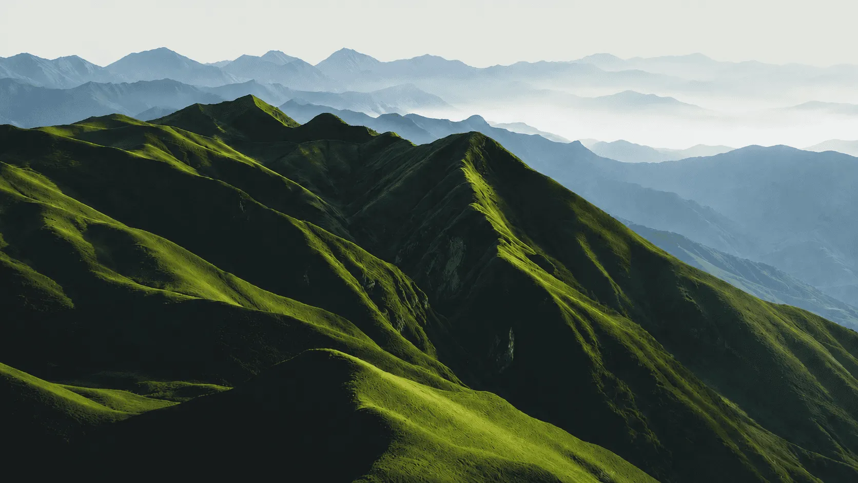 Hiker overlooking a mountain trail, representing Trova guided hiking adventures and outdoor travel planning.